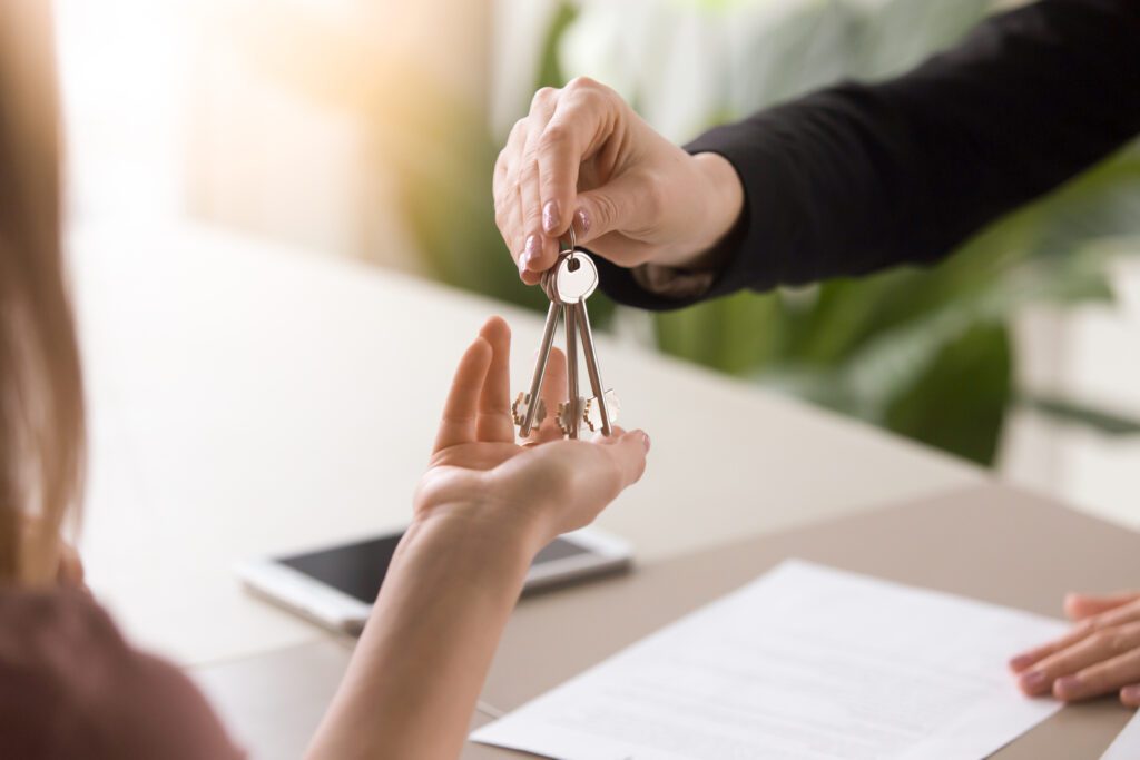 Young Lady Taking Keys From Female Real Estate Agent