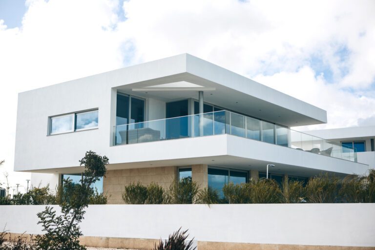 White residential building in the south of Portugal against the blue sky. A typical Portuguese architecture of houses and hotels.