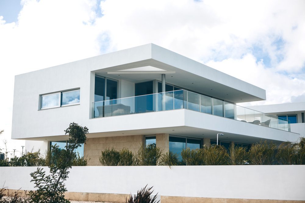 White residential building in the south of Portugal against the blue sky. A typical Portuguese architecture of houses and hotels.