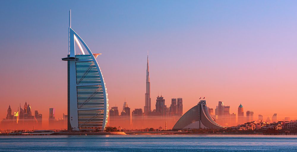 Dubai city - amazing city center skyline and famous Jumeirah beach at sunset